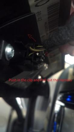 On the back of the top of the benzel, remove the Wire Harness for the Passenger Airbag Notification. 

Press In on the Clip and Pull Out.