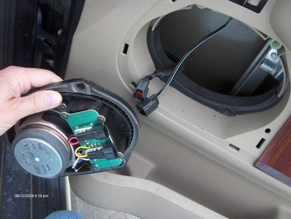 5a - Unplug speaker... these plugs, once again, come apart really easily, with one hand. Press the retaining tang, pull the plug. Aggression will not be rewarded. There are plastic "cups" which the screws screw into. Remove the lower two with a firm tug (with a pair of needle nose pliars).