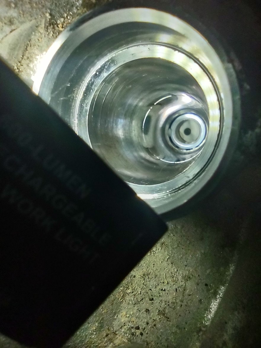 Looking down at the remaining part of the broken plug.