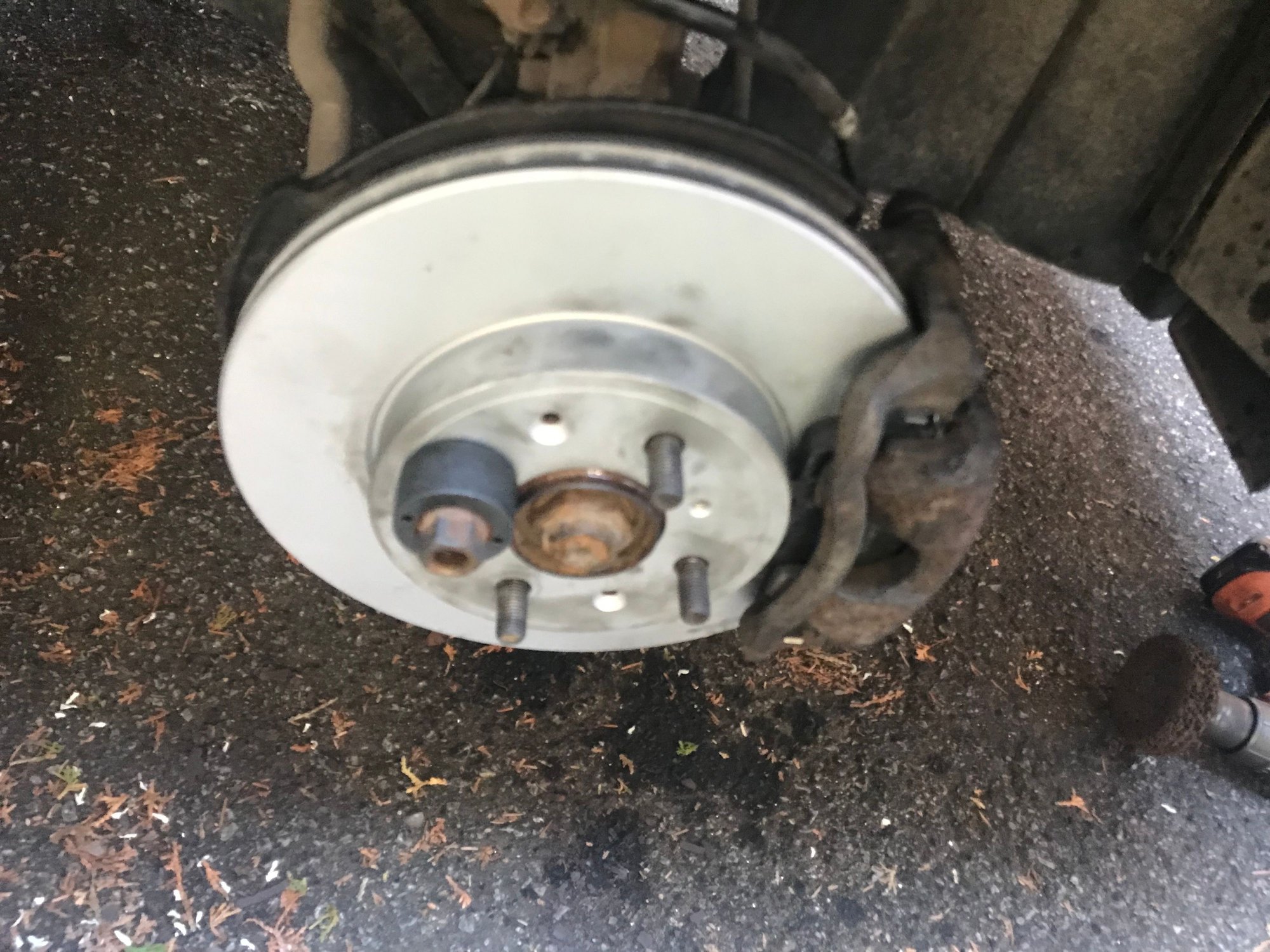 Used a wheel stud puller tool and a lug nut to hold on the rotor while I worked. I did clean the stains (probably MolyKote) prior to installing the wheel. I hate through style lug nuts and plan on getting some replacements from Kenny U Pull. 