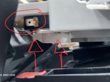 Lower view of disconnected switch and arrows to the bolts