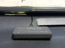 Flat wire comes straight out from front of windshield.  If you remove unit--unplug and you can push wire out of sight under the dash plastic if you want.