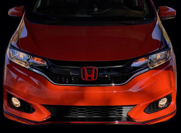 Blacked out with vinyl film top of grille and eyelids.