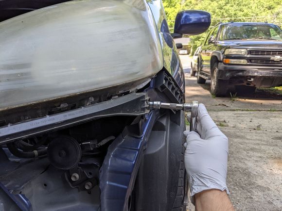 Hafta take the bumper off to get at this black bracket, then remove the bracket with the headlight (it sandwiches the headlight in & has alignment nubs that prevent removing the headlight without it)