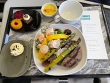 CDG-KEF Grilled Filet Steak with potato salad, asparagus, and sauce with bread and panna cotta mango