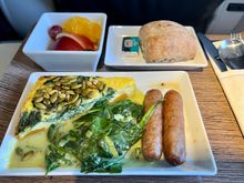 Winter Squash Frittata topped with pepitas, served with sautéed spinach and leeks, chicken cranberry sausage, warm raisin bread and fresh fruit.
