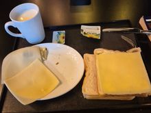 My breakfast, no coffee for me just a cuo of pure milk. Some bread and cheese.