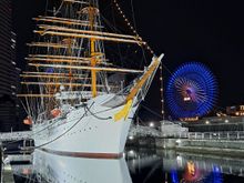 The nippon maru sailing ship and ferris wheel at night