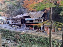 The ruins of the burnt down building ( burnt 4 days prior). Standing on the other side of the stream there was the occasional faint  burnt  odor in the air . The falls are just to the left with a couple of stands to the left. The 2nd floor viewing deck was closed 