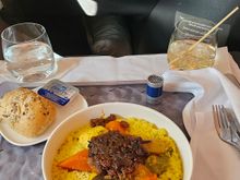 Chicken Tagine (hidden under caramelized onions) with Couscous and veggies. One of the extra meals available online for pre-select up to 24 hrs before.