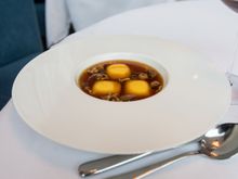 My wife's first course: Ravioli in a vegetarian onion and mushroom broth (she is pescatarian, which the restaurant easily accommodated).