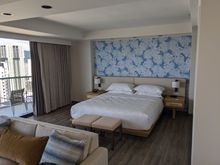 The bedroom portion of the Tower Corner Junior Suite, renovated. It has two sliding glass doors on one side, providing views of both the ocean and the mountains.