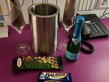 Sweets, nuts and small bottle of sparkling wine