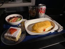 UA 200 GUM-HNL pre arrival meal warm Grilled chicken sandwich with fruits and strawberry cheesecake 