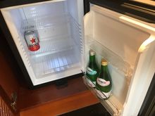 A minibar filled with 2x beer + 1 water + 1 sparkling water, enough space to store your own drinks