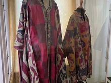 There are many displays of traditional clothing, carpets, china, and more
