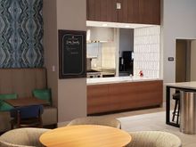 Open door to staff-only prep/service area with chef's counter to the left. 