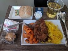 More petite version of the Persian chicken.  No salad.  Little macaroon dessert.  SFO (changed to OAK) DAL lunch.  Plastic for beverages.  Beverage cup empty for an hour.  Then I used call bell.  Then others also asked for things.