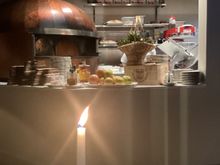 Looking into kitchen with pizza oven