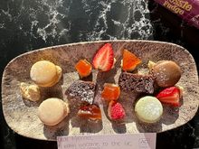 Plate of fruit and macarons.
