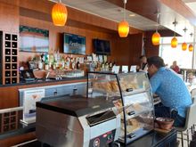 The bar area has a mobile toastière and bread display