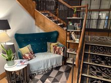 A waiting nook under the staircase with 