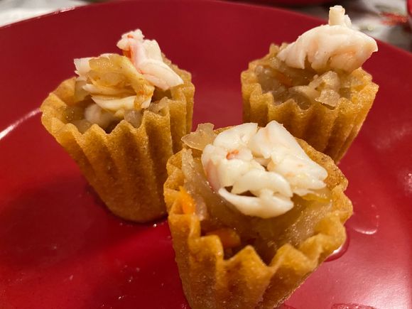 Kueh pie tie - has turnip , etc filling topped with prawn . Not shown the coriander / parsley garnish , chilli sauce , dark sweet sauce to taste