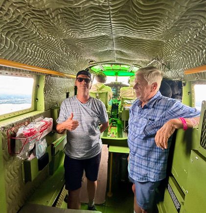 In the front section, behind the pilots and in front of the two forward passenger seats 