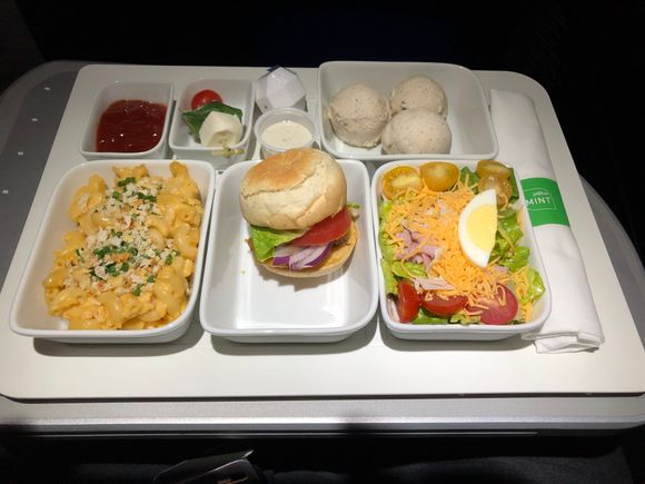 Starting from lower right: chef’s salad, classic cheeseburger, mac&cheese, ketchup, tomato basil mozzarella skewer, and ice cream.