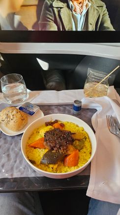Chicken Tagine (hidden under caramelized onions) with Couscous and veggies. One of the extra meals available online for pre-select up to 24 hrs before.