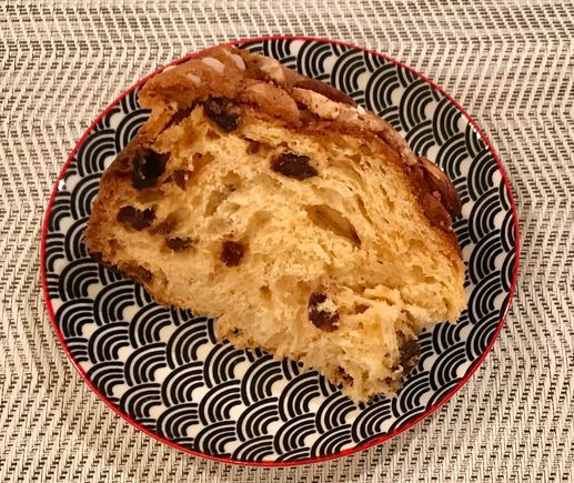 A slice of the panettone with lots of Sicilian almonds , ..