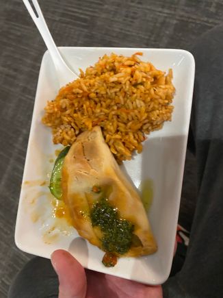 An empanada doused in chimichurri sauce & some Spanish rice.   The rice actually had quite a kick!   Surprised me!
