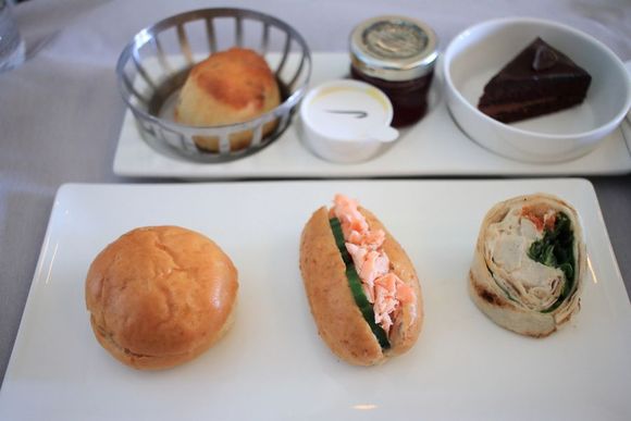 Sandwich selection, plain scone and chocolate glaze cake
