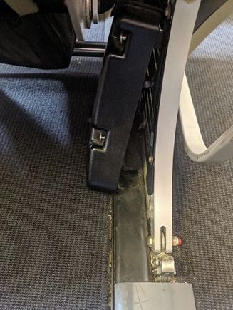 loose screw and plastic cover under the seat in front of mine
