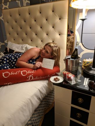 Welcome Amenity consisting of Prosecco, Truffles, and Cupcakes with handwritten note identifying birthday girl by name.