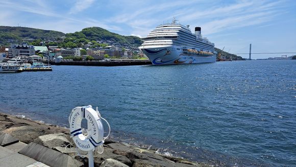 A large cruise ship  taken from the Nagasaki sea side park ( nice park and walking path). Glover garden to the left.  From my room at the hilton I could see the ship set sail in the evening. The next day another cruise ship docked ( Silversea ) but was smaller than this ship