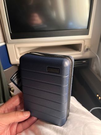 New amenity kit - hard sided but will easily crush due to cloth hinge / zipper