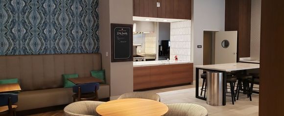 Open door to staff-only prep/service area with chef's counter to the left. 
