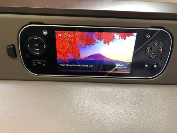 The handheld console was a comfortable distance from my right hand I was able to easily use it without ever taking it out of its holder. I used the call button a couple times and a flight attendant always came out within 5 to 10 seconds.