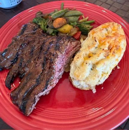 Skirt steak (flap meat from Costco) brushed with Sweet Baby Ray’s and grilled, with twice baked potatoes (from KC Cattle Co. - don’t bother) and sautéed veggies. 