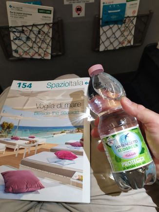 Air Dolomiti inflight magazine and a bottle of mineral water from the Dolomite mountains