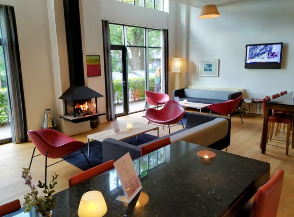 Homely bar area with a lit fire in the Radisson Blu Silkeborg 