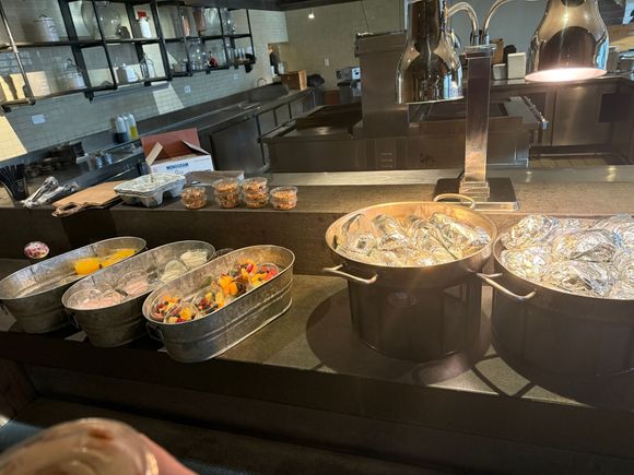 To-go breakfast options: chorizo breakfast burritos or croissant sandwiches. Includes fruit or yogurt and orange juice