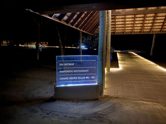 Night view of the transition from beach villas to grand water villas