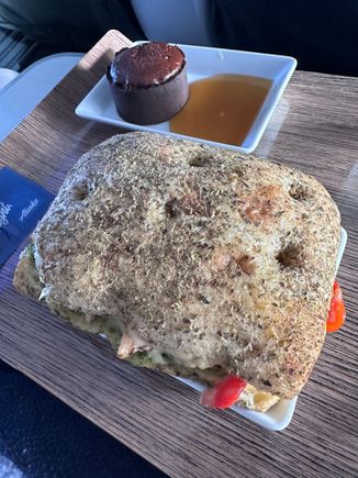 Pesto chicken sandwich was good, but difficult to eat due to size and it was falling apart. The brownie tart with caramel sauce was AMAZING! First time I’ve seen this in a first class flight- I created an account to post. Hopefully they continue. 