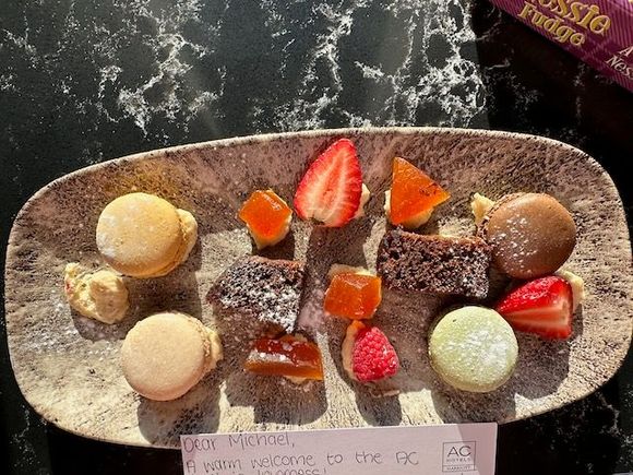 Plate of fruit and macarons.