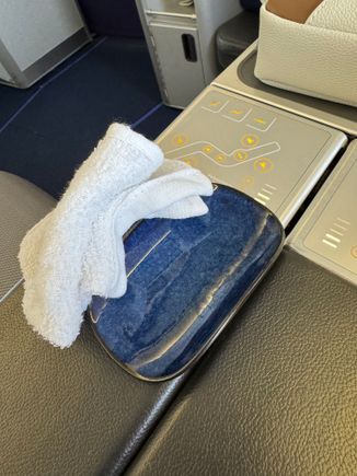 Hot towel presented on a little ceramic dish.