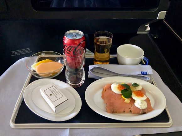 Smoked salmon and quail egg sandwich, fresh fruit and chocolates