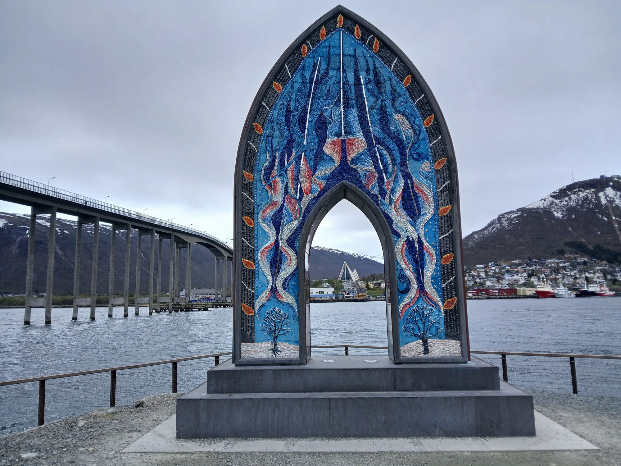 The gateway to the Arctic, a 6 metre tall mosaic sculpture with a portal perfectly framing the Arctic Cathedral