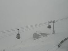 There’s a long, 4-kilometer gondola ride (12 minutes) to the top of the Kronplatz—elevation 2,275 meters (about 7,500 feet). The man selling tickets at the lower station casually said, “You know it’s snowing at the top of the mountain, right?” That became evident about halfway up.
